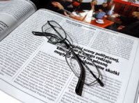 magazine article with folded glasses laying on it